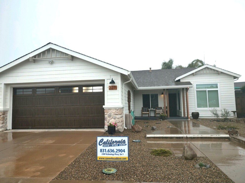Residential garage door install with California Overhead Door yard sign