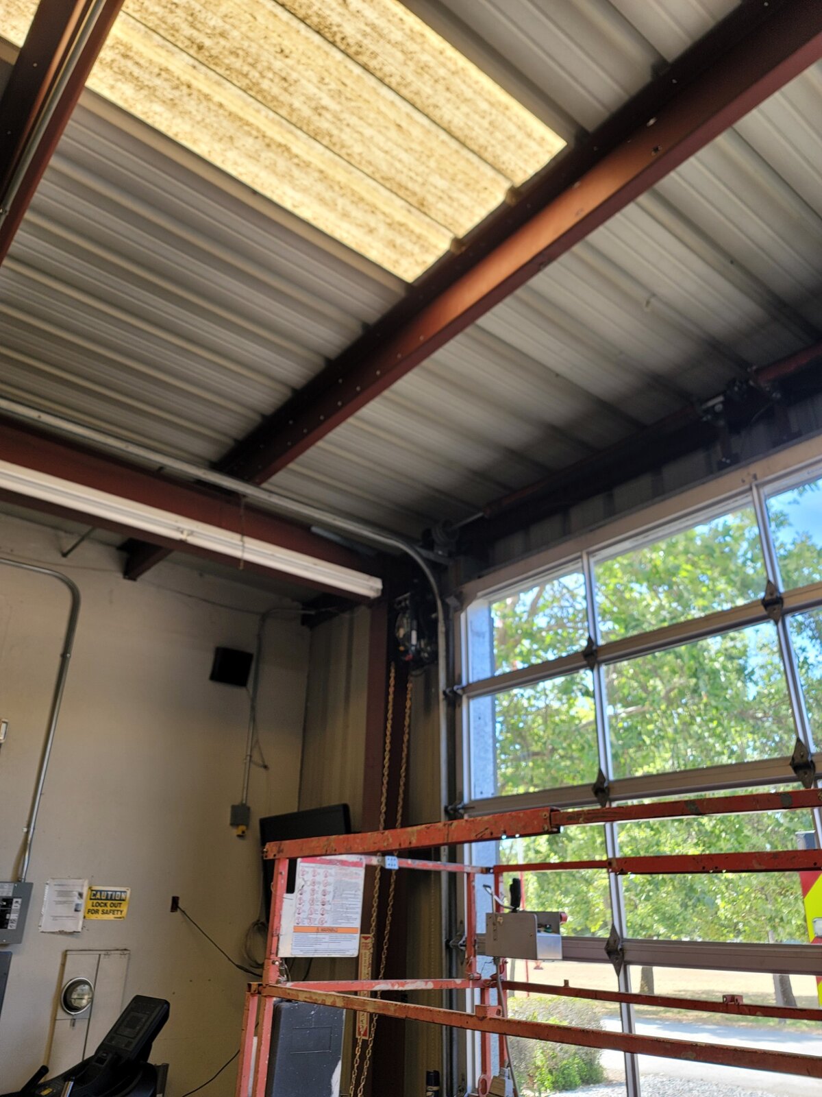 Full-view glass overhead door in a metal commercial building