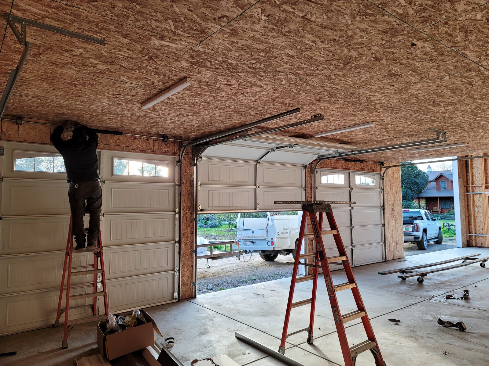 Residential garage door installation in progress on a new build