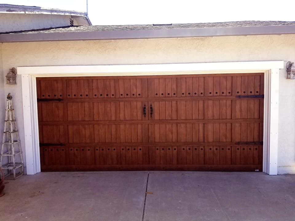 Technician performing garage door maintenance