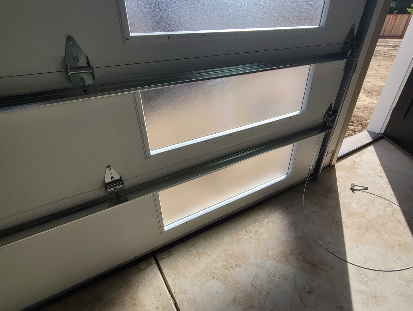 Lubricating garage door rollers and hinges