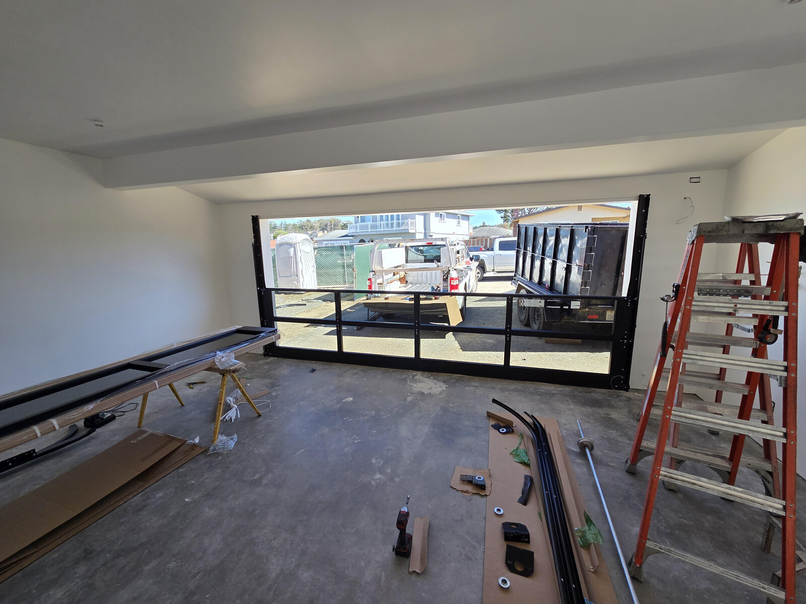 Full-view glass garage door installation, interior view