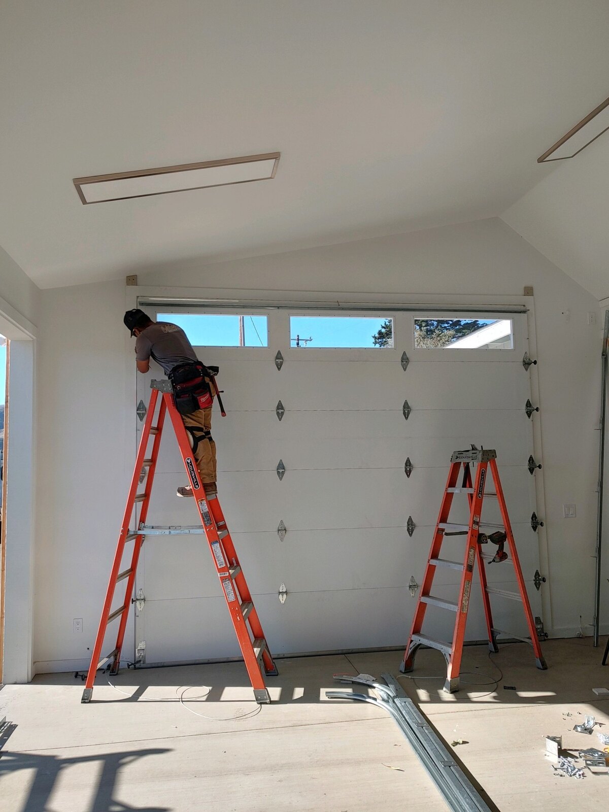 Technician installing a residential garage door