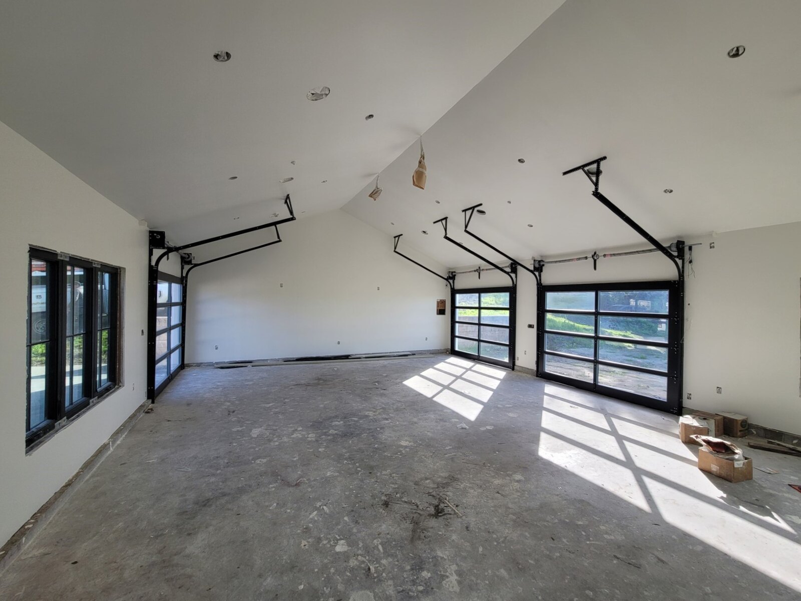 Full-view glass garage doors in a modern home interior
