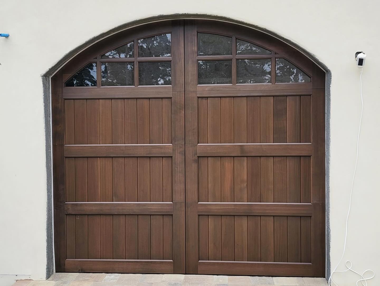 Spanish-style estate with wood carriage-house doors