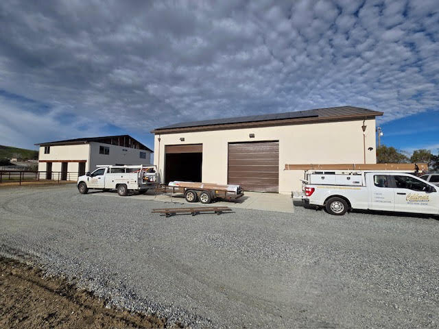 Commercial building with a sectional overhead door and service vehicles