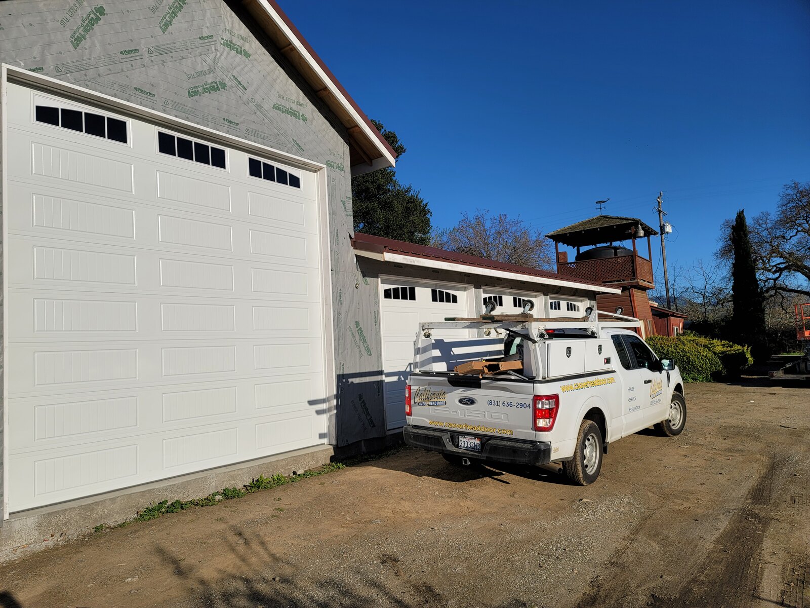 New white steel garage door on a ranch-style Central Coast home