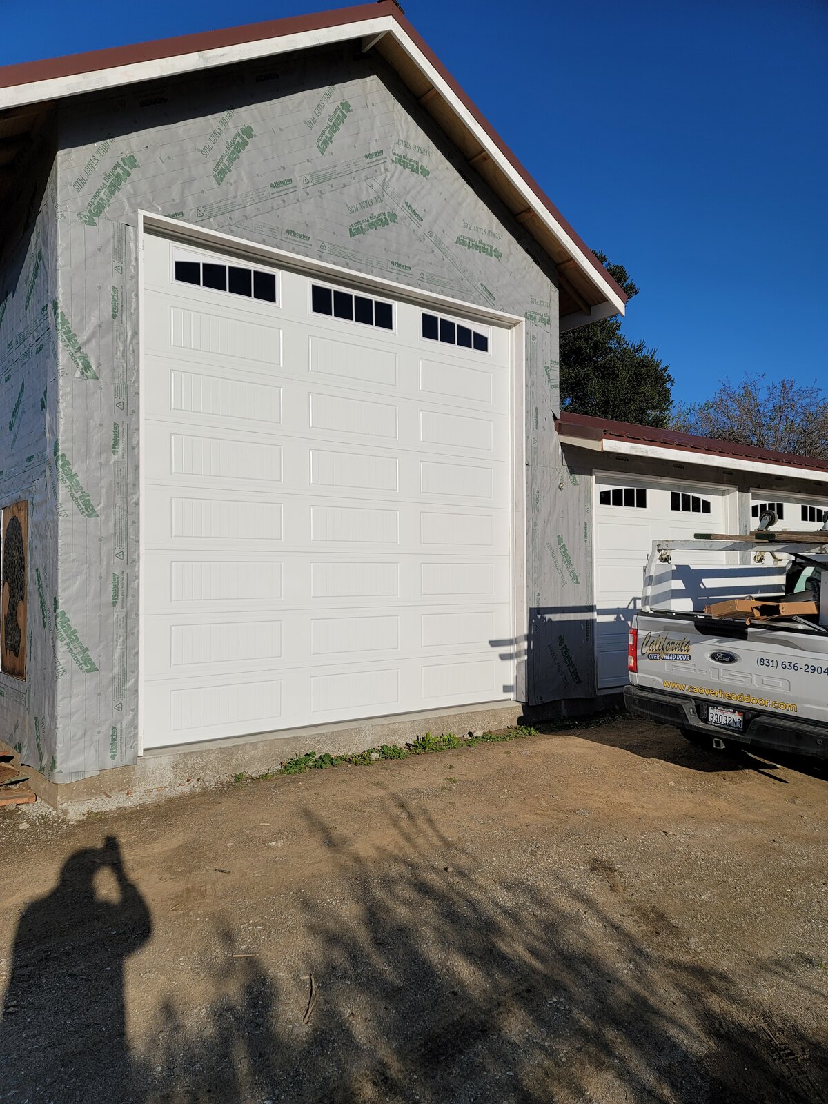 New white sectional garage door with California Overhead Door service truck