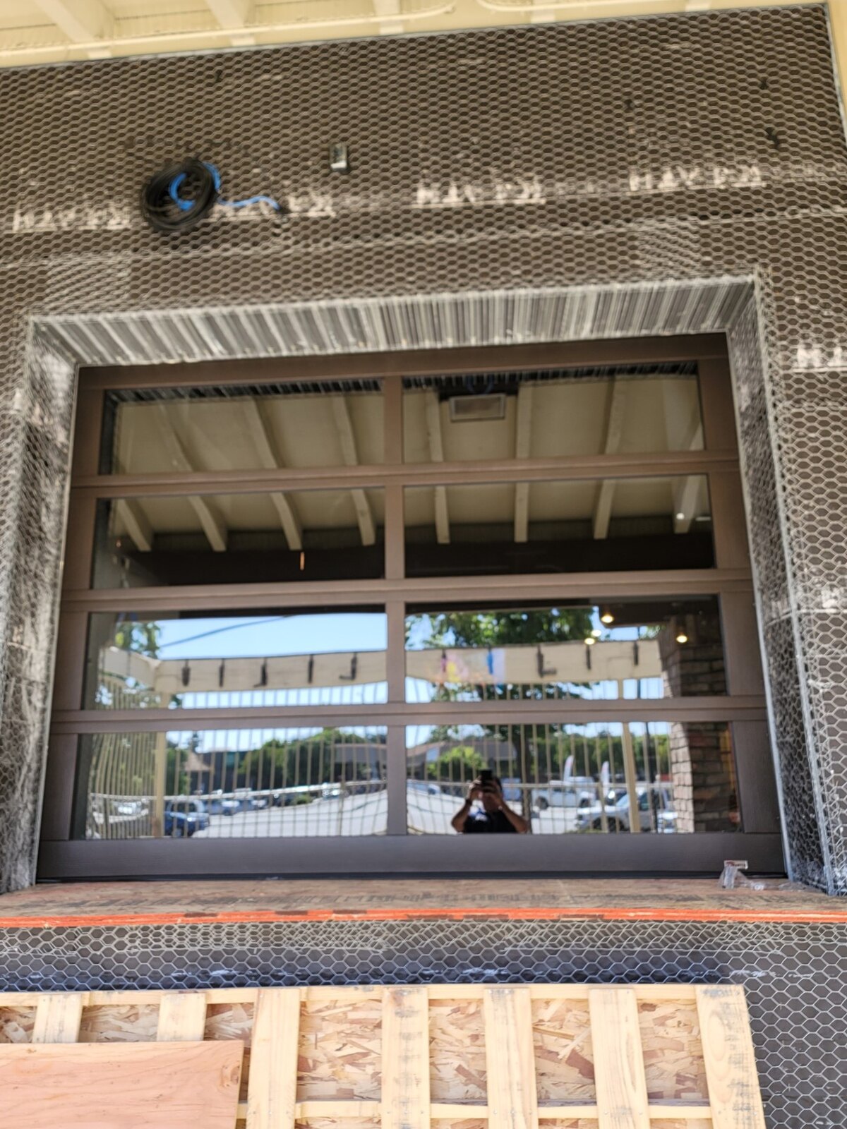 Tall commercial sectional door with full-view glass, interior