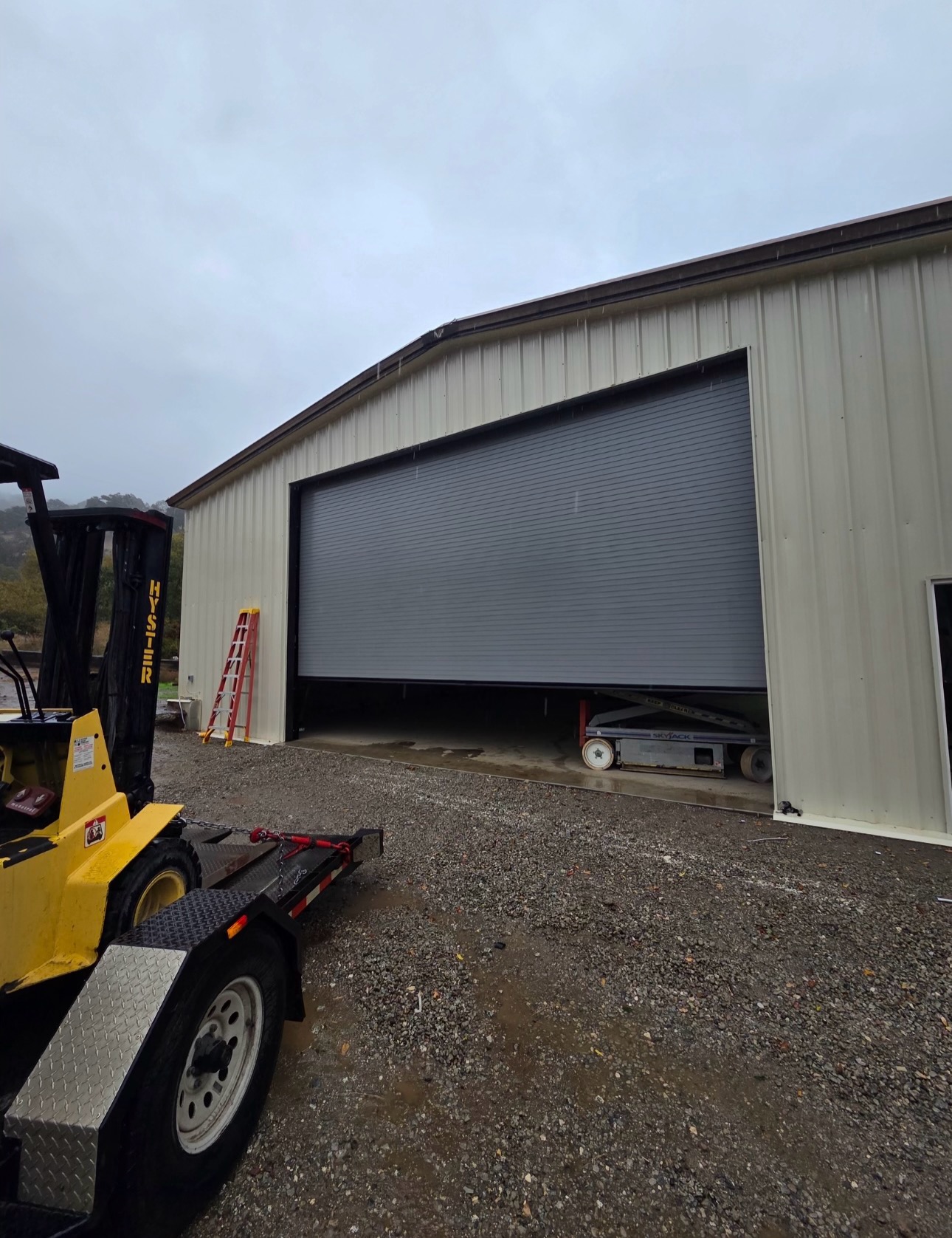 Industrial warehouse interior with rolling-steel doors and forklift
