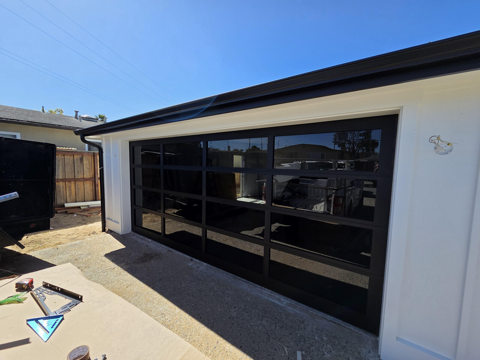 Modern full-view glass garage door on a contemporary home