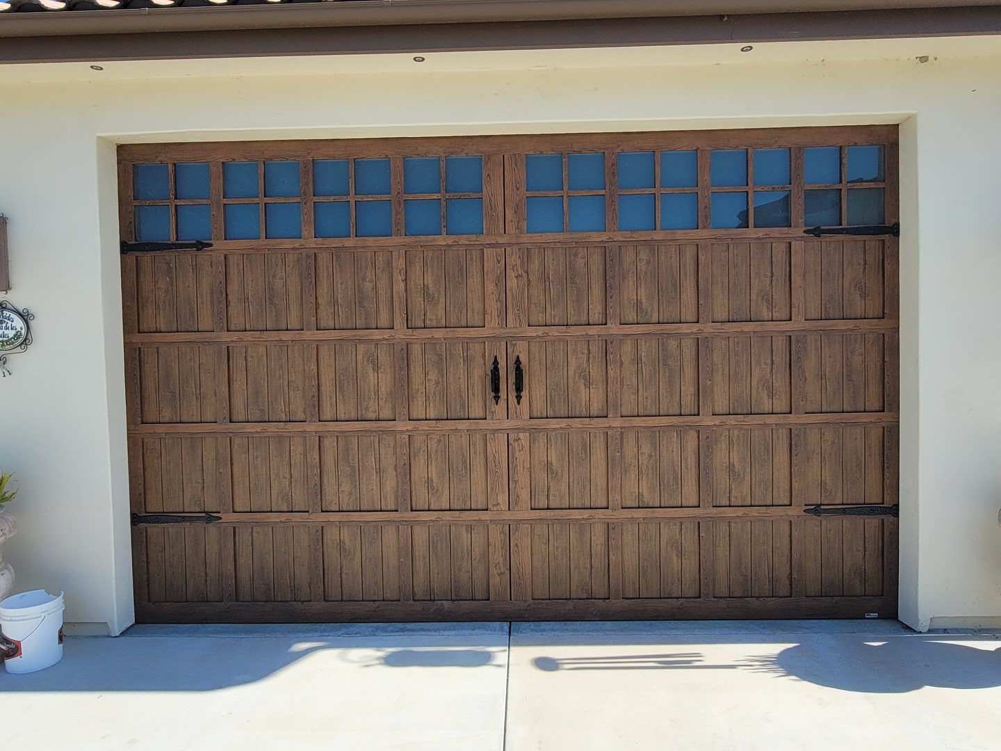 Wood-grain sectional garage door on a residential home