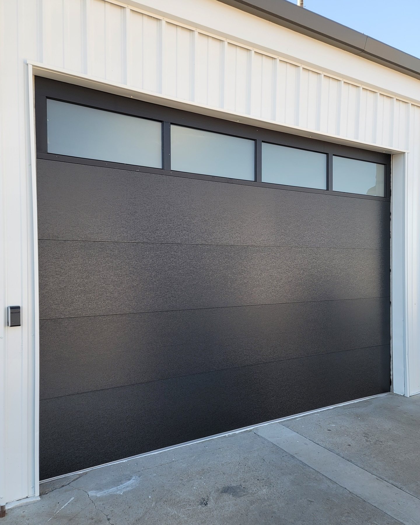 Modern flush-panel sectional garage door