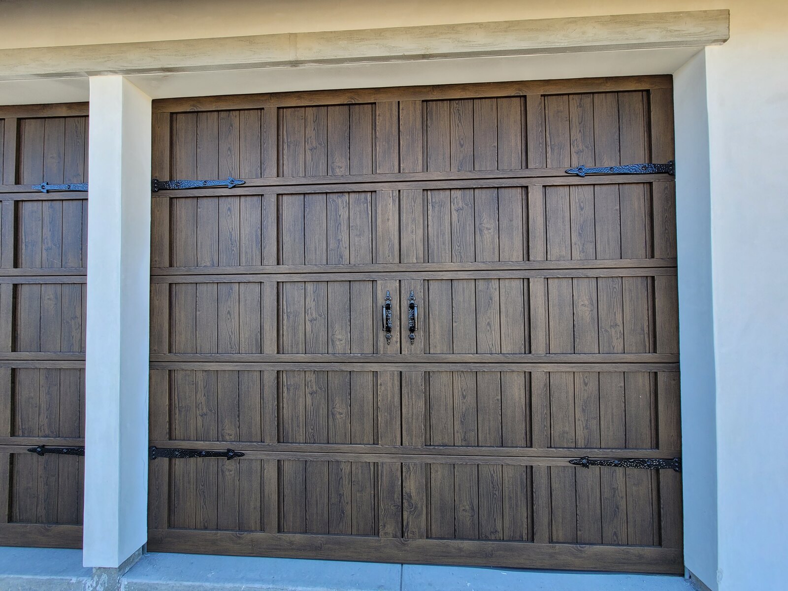 Wood-grain carriage garage door on a Central Coast home