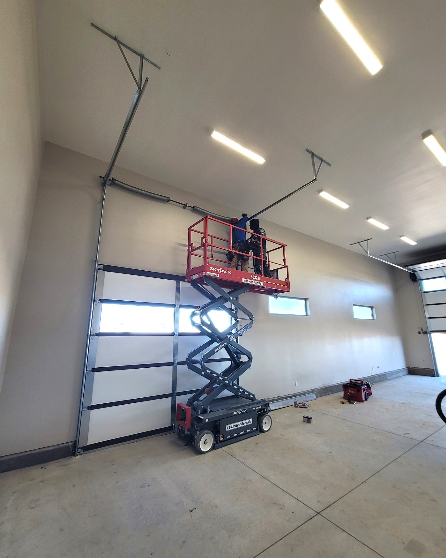 Technician servicing a commercial overhead door