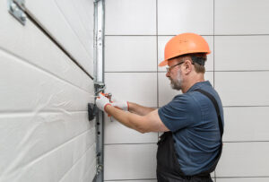 Worker installing garage door - Garage door services